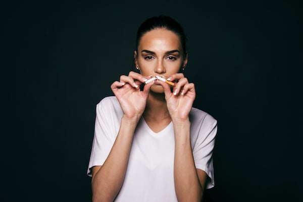 girl quit smoking concept break the cigarette