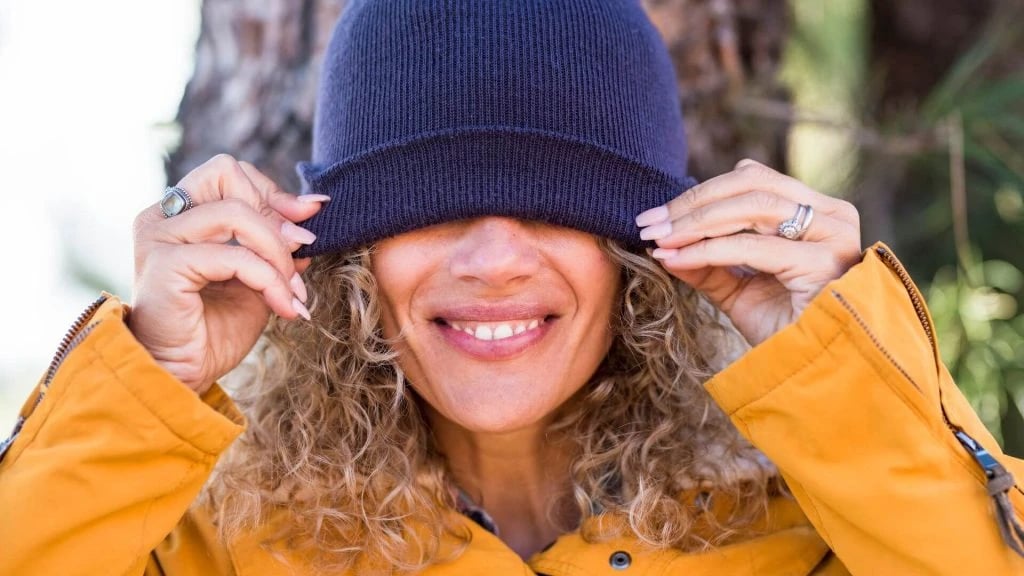 a women wearing a wool hat and smiling