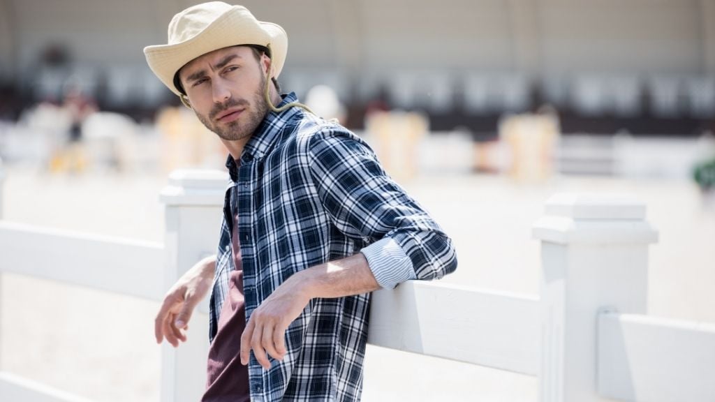 a man leaning on the fence