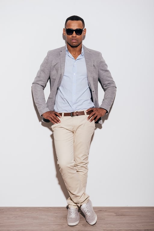 a stylish short man striking a pose
