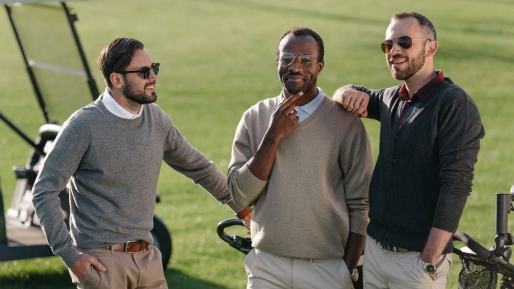3 Guys talking to each other at a Golf Course