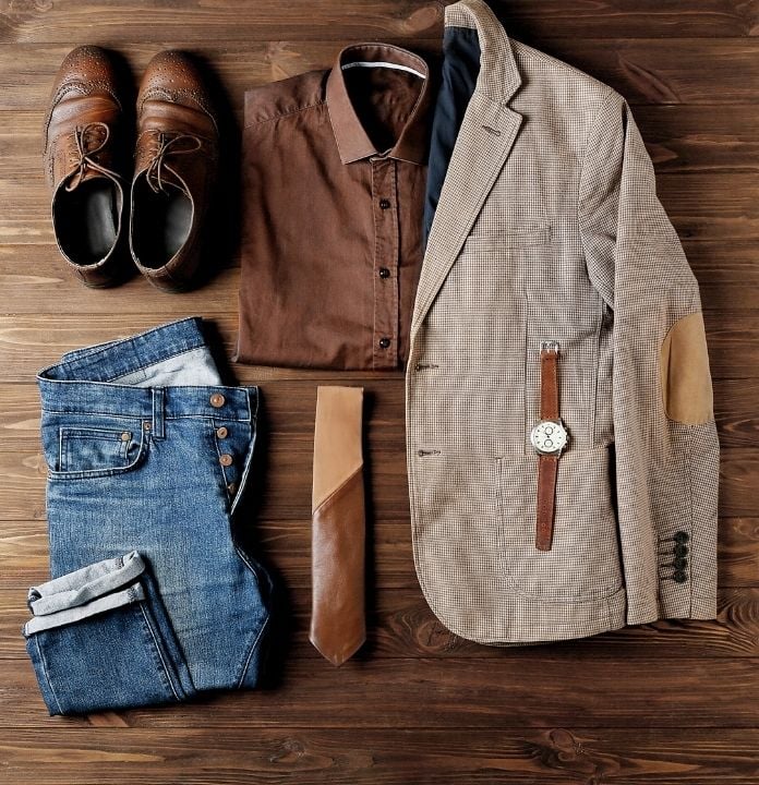 a set of clothes on the table such as blazers, shirts, pants and shoes