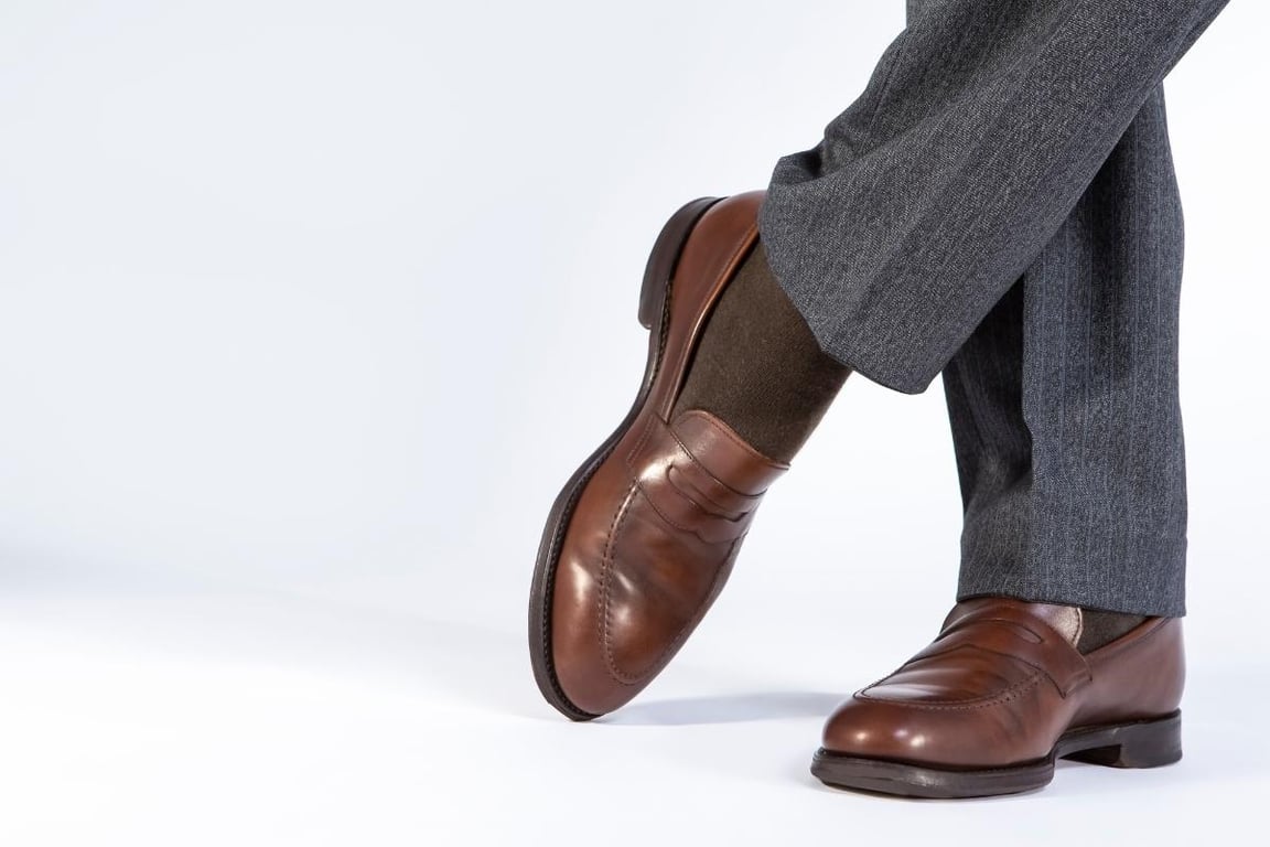 a shot focus on the loafer shoes that a man is wearing