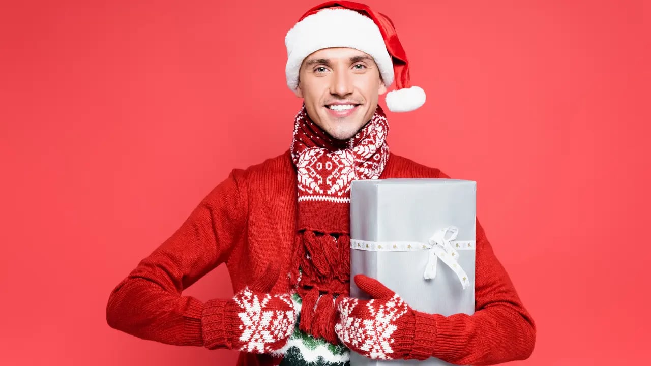 a man wearing a christmas outfit with gifts
