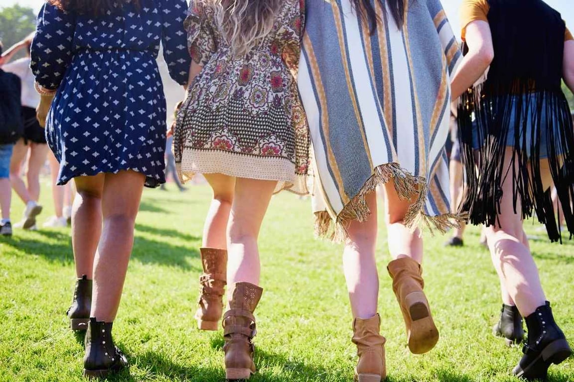 Women walking on the grass at Coachella