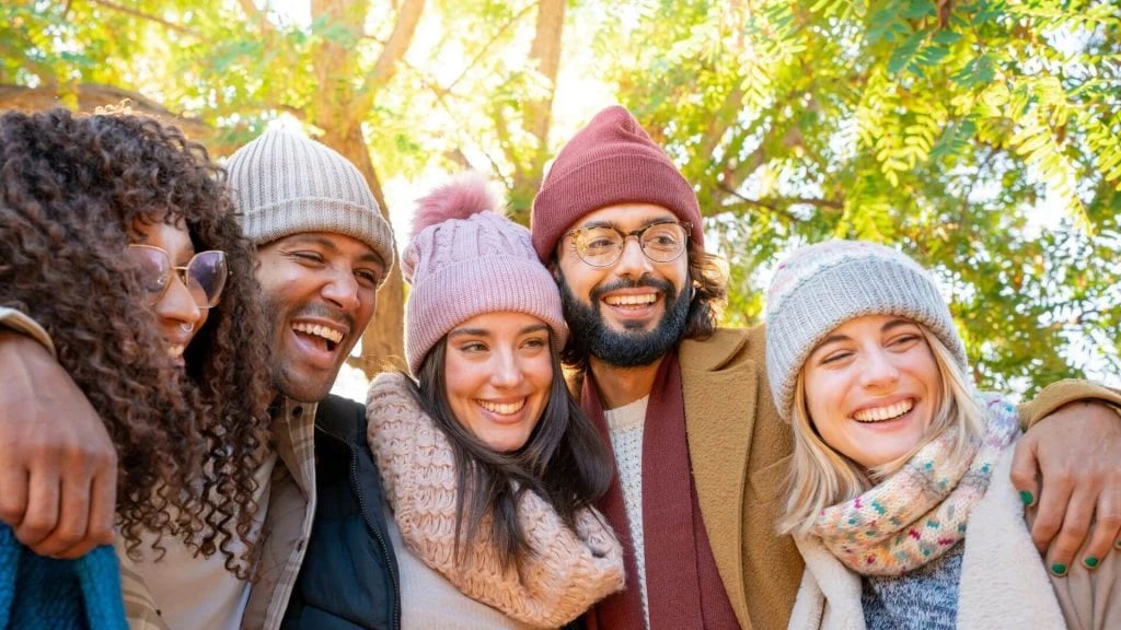 Friends wearing wool hat and smiling