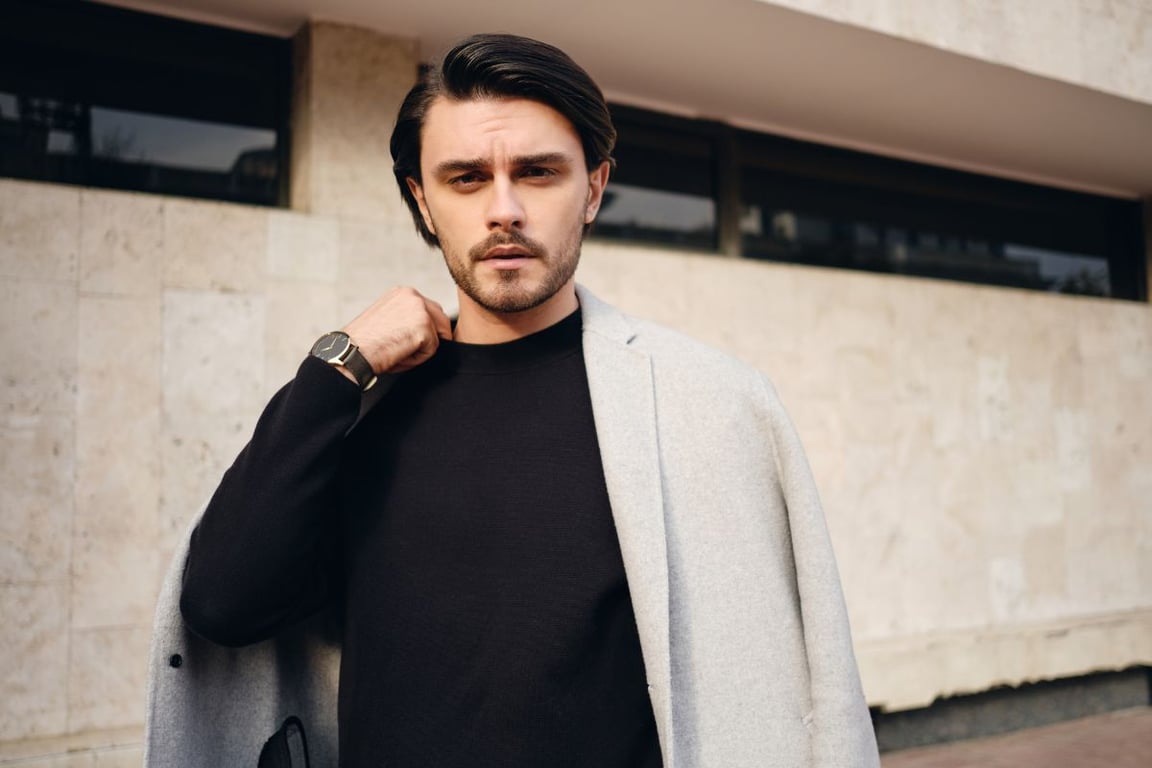 a man wearing a blazer on top of his long sleeves shirt