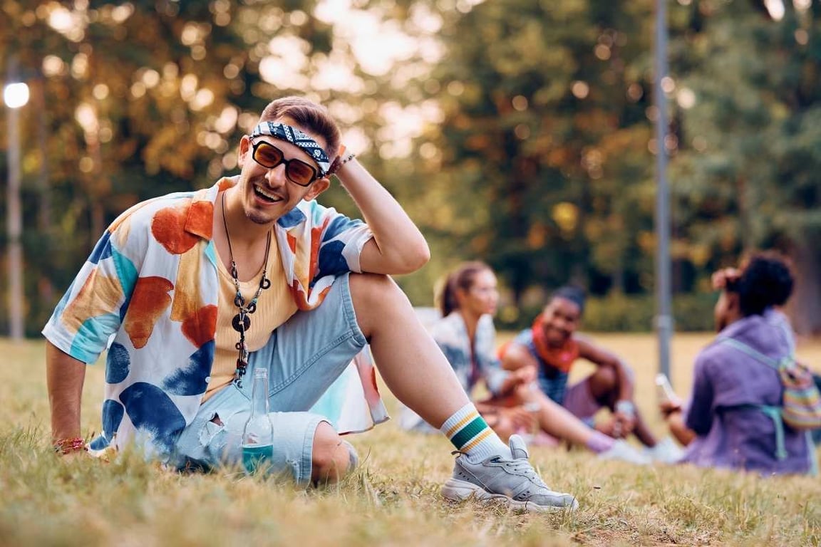 a man sitting on the grass at Coachella